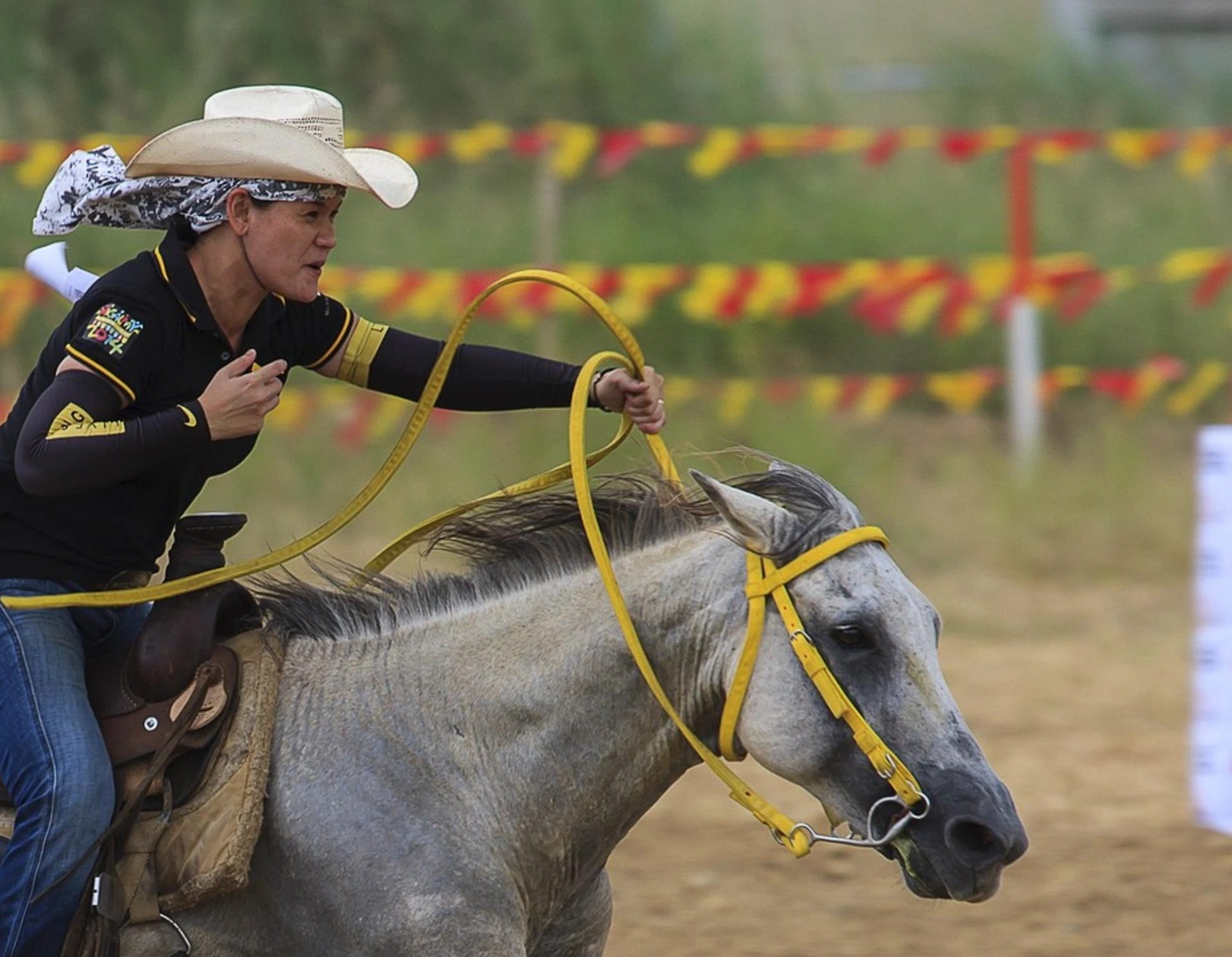 A cowboy holds the reins loosely even during intense rodeo