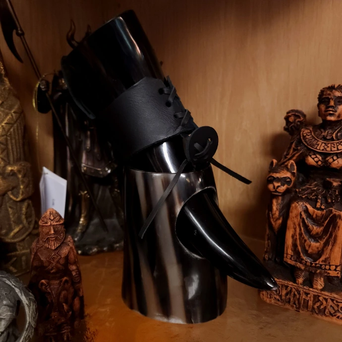 A Viking-style drinking horn on a shelf